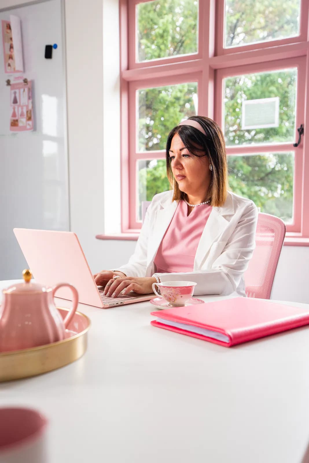 A member of the Girl Boss team working at a laptop in the Cherry Tree House office.