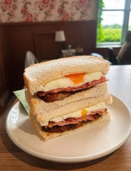 A Cherry Tree Stack breakfast sandwich served in a soft sourdough roll