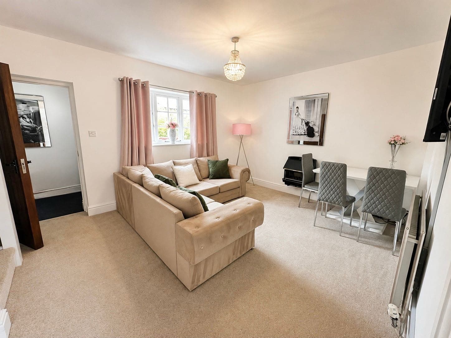 The sitting room at Cherry Tree House with a dining table beside the window